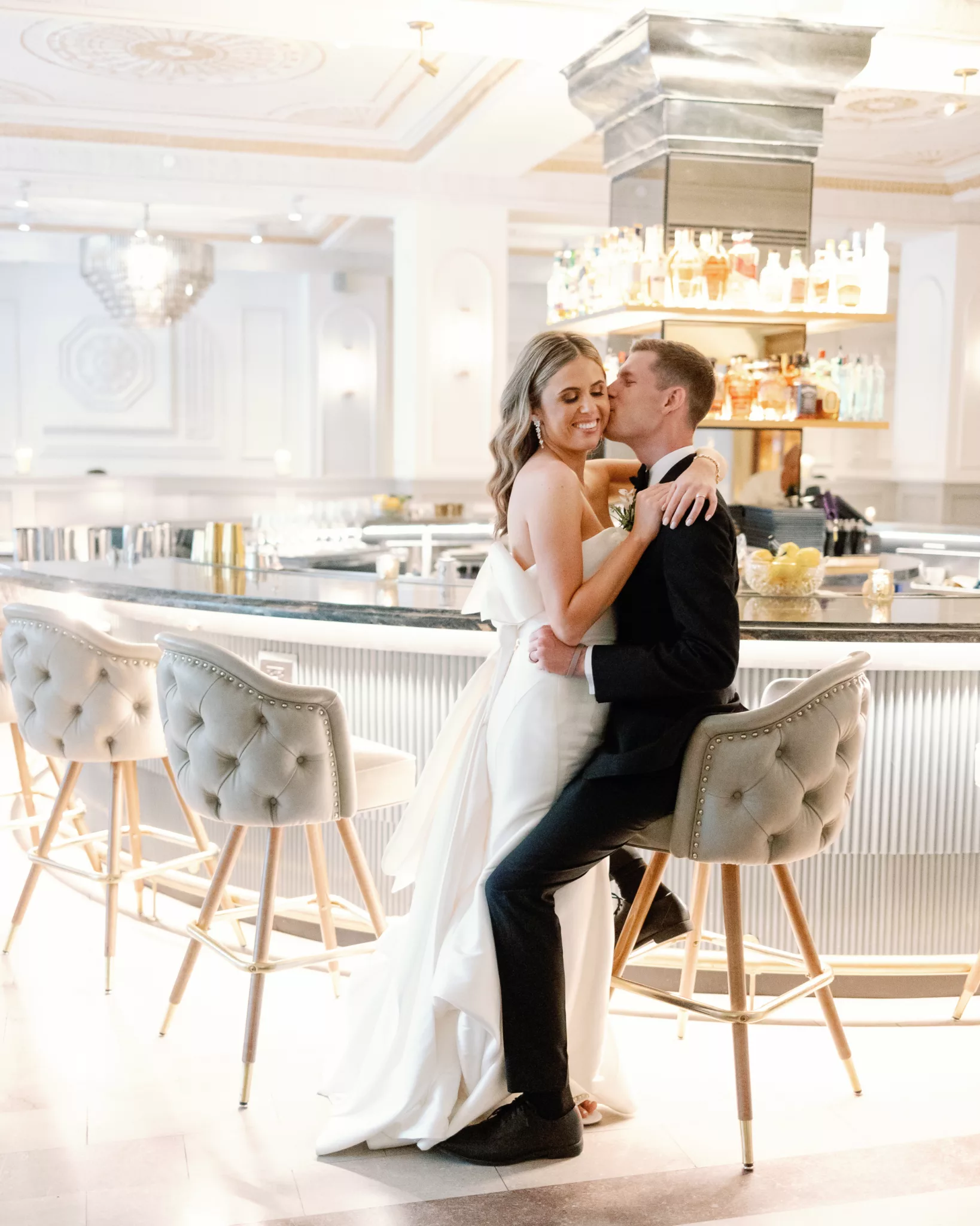 Bride and groom embrace inside chic bar in downtown Des Moines on their wedding day