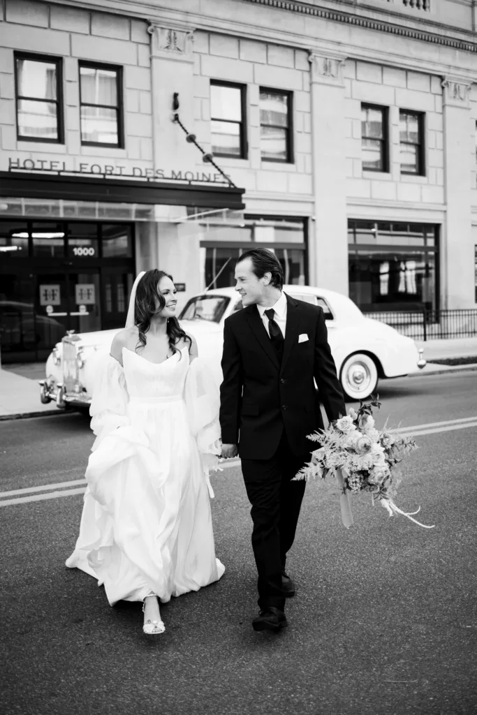 Bride and groom walk across the street for Hotel Fort Des Moines wedding